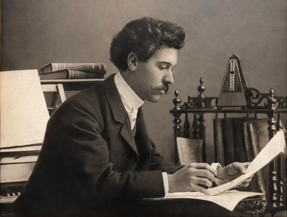 Young Albert Dupuis composing, sepia photograph